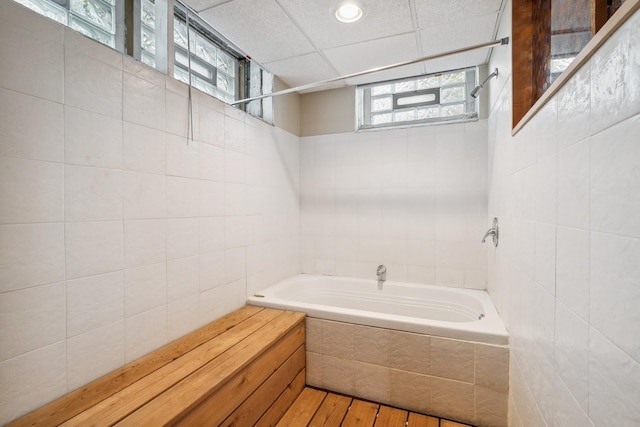 5026 Nokomis Ave, Minneapolis, MN 55417 - bathroom with tiled tub, tile walls, wood finished floors, and tiled shower