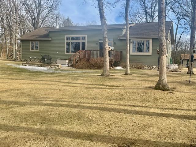 exterior space with a lawn and a wooden deck