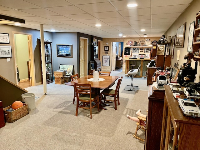 dining area with recessed lighting, light colored carpet, a paneled ceiling, and baseboards