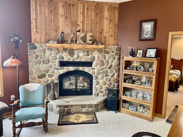 living room featuring carpet floors and a stone fireplace