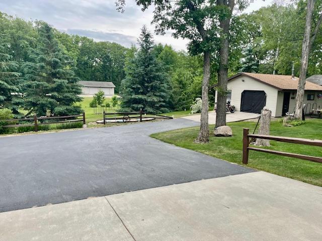 26909 Lake Ethel Rd, Girard Twp, MN 56515 - exterior space with concrete driveway and a garage