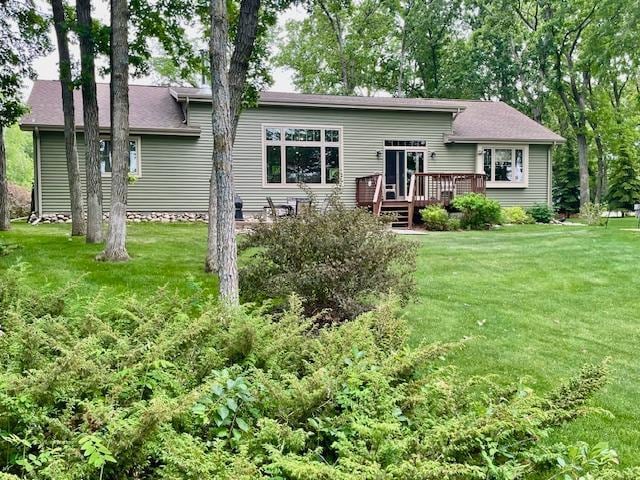 26909 Lake Ethel Rd, Girard Twp, MN 56515 - rear view of property featuring a deck and a yard