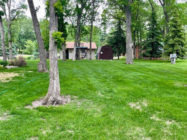 26909 Lake Ethel Rd, Girard Twp, MN 56515 - view of grassy yard featuring a barn and an outdoor structure