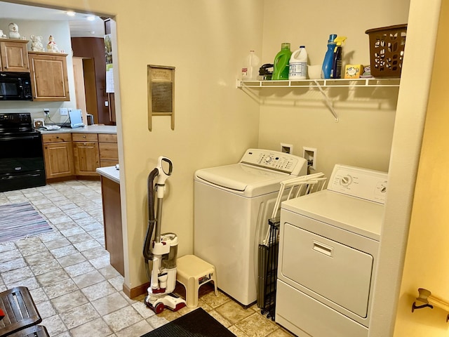 26909 Lake Ethel Rd, Girard Twp, MN 56515 - washroom featuring washing machine and clothes dryer, baseboards, and light stone finish floors