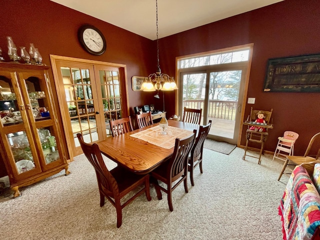 26909 Lake Ethel Rd, Girard Twp, MN 56515 - dining room featuring light colored carpet, french doors, a chandelier, and lofted ceiling