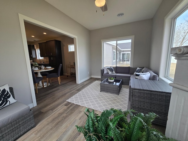 living room with recessed lighting, visible vents, baseboards, and light wood finished floors