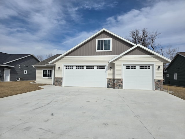 craftsman-style home featuring board and batten siding, concrete driveway, and stone siding