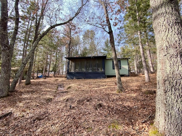 view of outbuilding featuring a sunroom