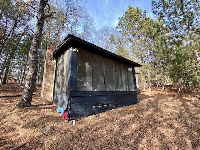 view of outdoor structure featuring a sunroom