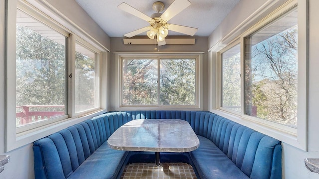 sunroom / solarium featuring a ceiling fan