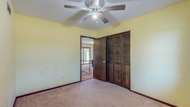 unfurnished bedroom with a closet, visible vents, baseboards, and carpet