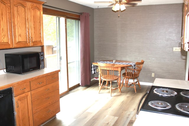 kitchen with brown cabinets, black appliances, a ceiling fan, light wood finished floors, and light countertops