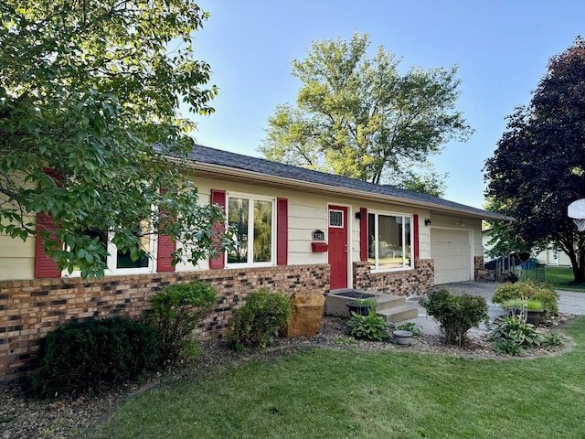 ranch-style house with a front yard, an attached garage, brick siding, and driveway