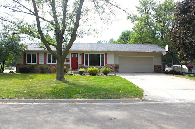 ranch-style house featuring a front lawn, stone siding, a garage, and driveway