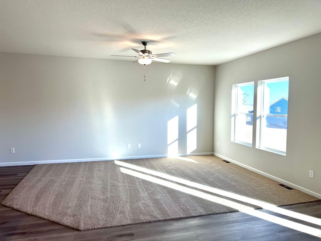 empty room featuring visible vents, baseboards, and a textured ceiling