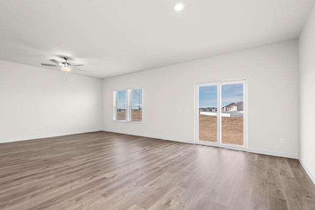 18746 Ivanhoe St NW, Elk River, MN 55330 - empty room with light wood-style floors and a ceiling fan