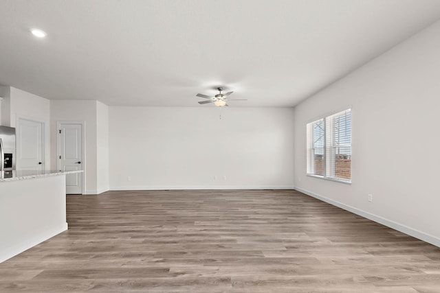 18746 Ivanhoe St NW, Elk River, MN 55330 - unfurnished living room featuring a ceiling fan, light wood-type flooring, and recessed lighting