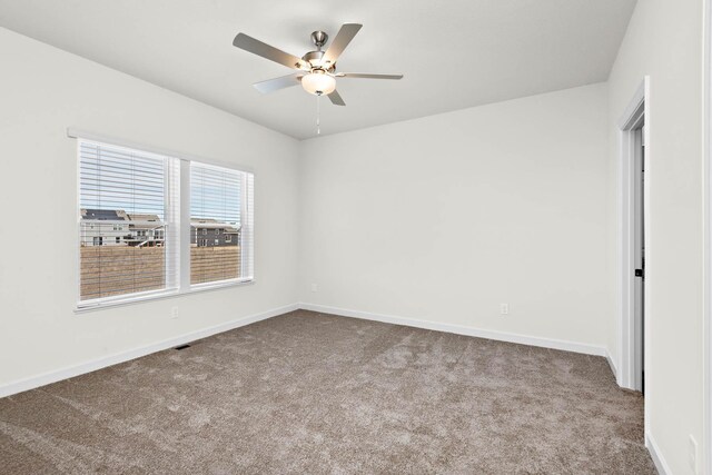 18746 Ivanhoe St NW, Elk River, MN 55330 - carpeted spare room with baseboards and ceiling fan
