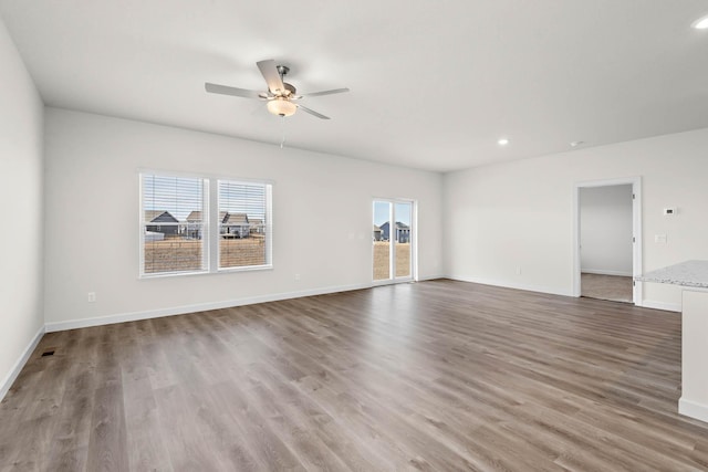 18746 Ivanhoe St NW, Elk River, MN 55330 - unfurnished living room featuring ceiling fan, wood finished floors, and recessed lighting