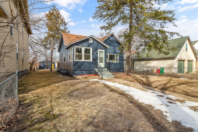 view of front of home with fence and roof with shingles