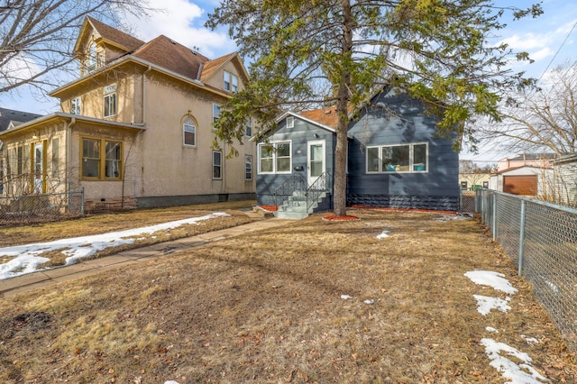 view of front of home featuring crawl space, stucco siding, entry steps, and fence