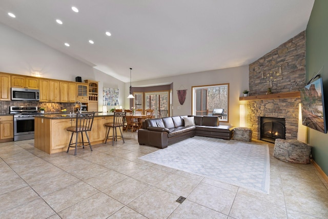 living room with light tile patterned flooring, a stone fireplace, recessed lighting, and high vaulted ceiling