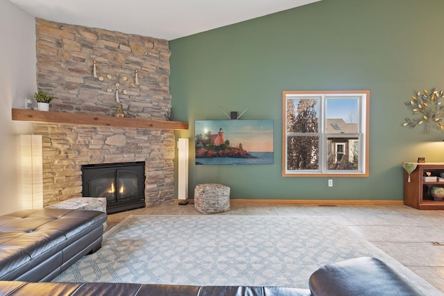 living room with tile patterned flooring, lofted ceiling, a fireplace, and baseboards