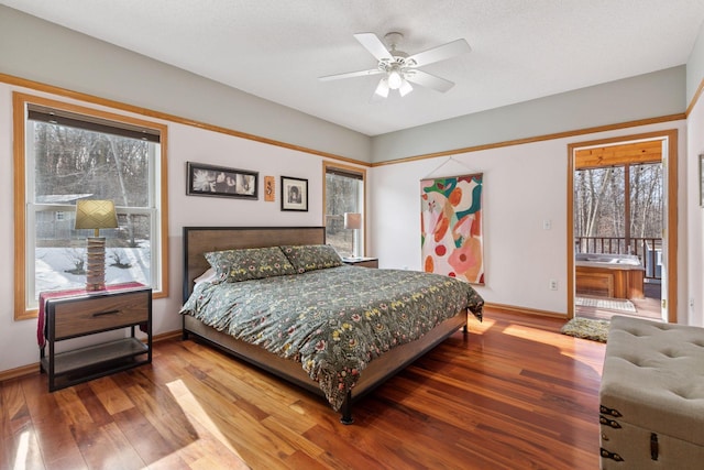 bedroom featuring wood finished floors, baseboards, and ceiling fan