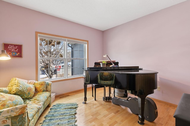 sitting room featuring light wood finished floors and baseboards