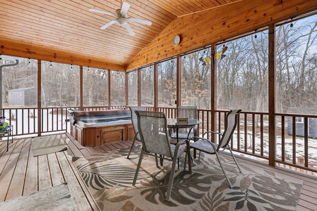 sunroom featuring wooden ceiling, a hot tub, a ceiling fan, and vaulted ceiling