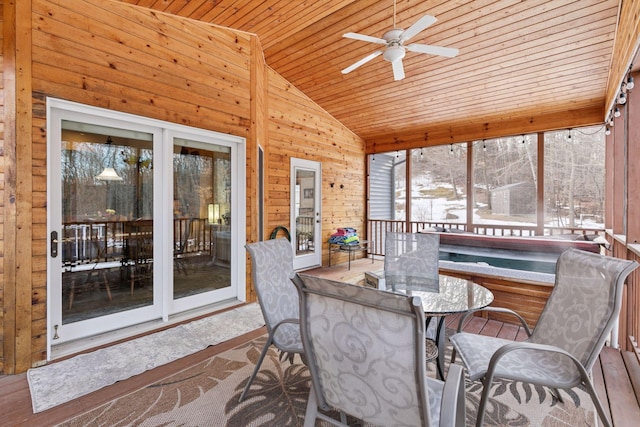 sunroom / solarium featuring wooden ceiling, a ceiling fan, and vaulted ceiling