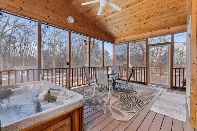 sunroom with plenty of natural light, wooden ceiling, a ceiling fan, and vaulted ceiling