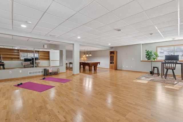 workout room featuring visible vents, billiards, a paneled ceiling, and wood finished floors