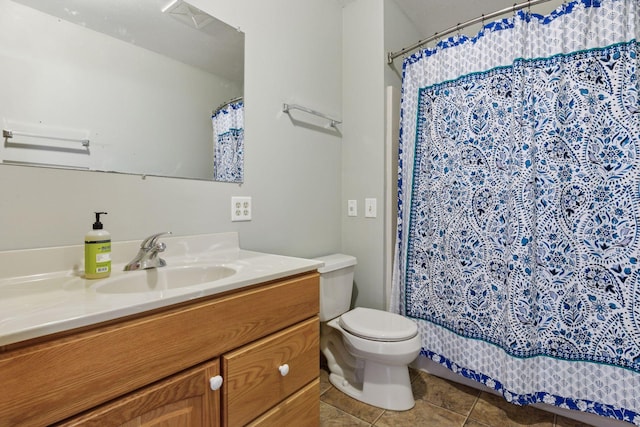 full bathroom featuring curtained shower, toilet, vanity, and tile patterned flooring