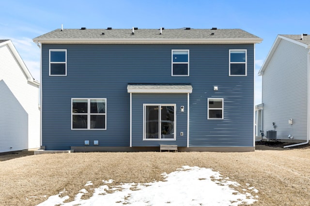 back of property featuring central AC