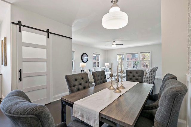 79 Western Ave N Unit 308, Saint Paul, MN 55102 - dining space with a barn door, a ceiling fan, and baseboards