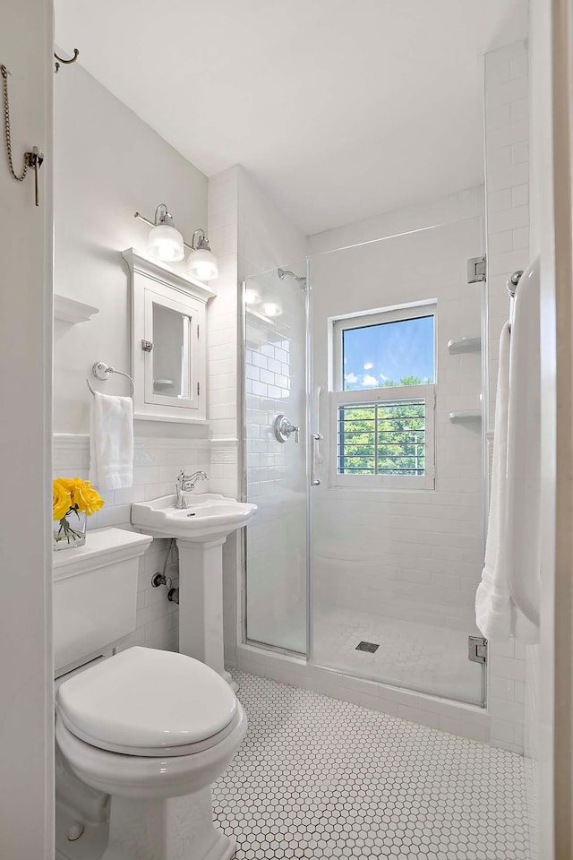 79 Western Ave N Unit 308, Saint Paul, MN 55102 - full bath with a stall shower, toilet, and tile patterned flooring