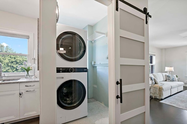79 Western Ave N Unit 308, Saint Paul, MN 55102 - laundry area featuring stacked washer / dryer and a barn door