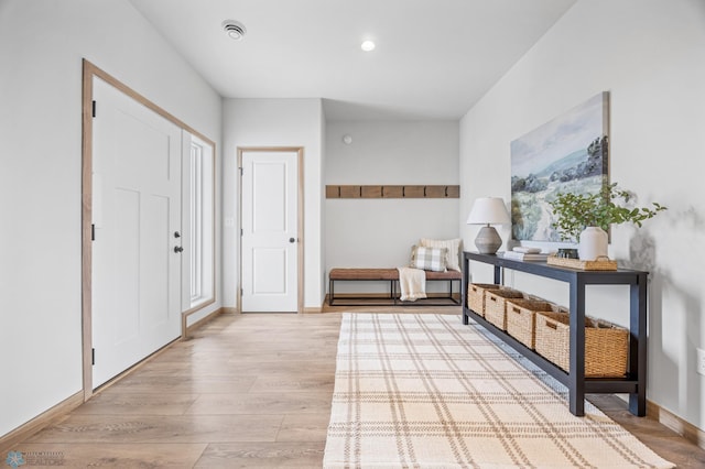 entryway featuring recessed lighting, baseboards, and light wood-style flooring