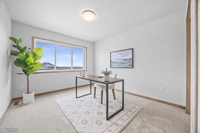 office with baseboards, visible vents, and light colored carpet