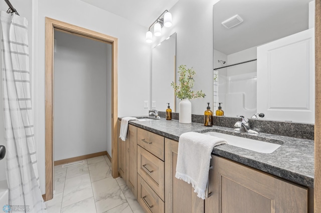 bathroom featuring double vanity, visible vents, a sink, and marble finish floor