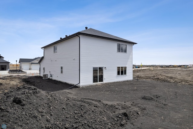 rear view of property featuring central air condition unit