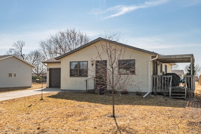 view of front of property with concrete driveway and a garage