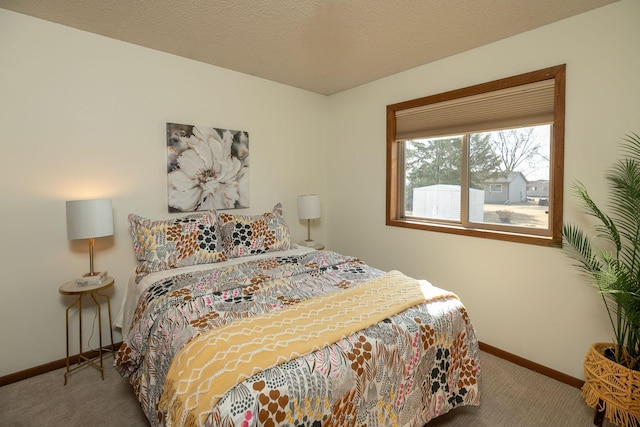 bedroom featuring baseboards, carpet floors, and a textured ceiling