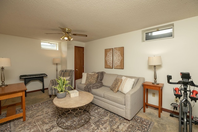 living room featuring baseboards, a textured ceiling, and ceiling fan