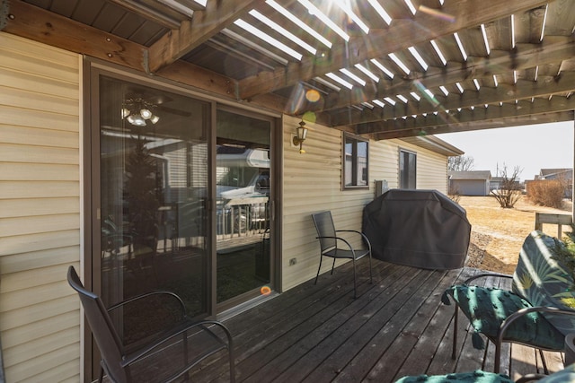 wooden terrace with grilling area and a pergola