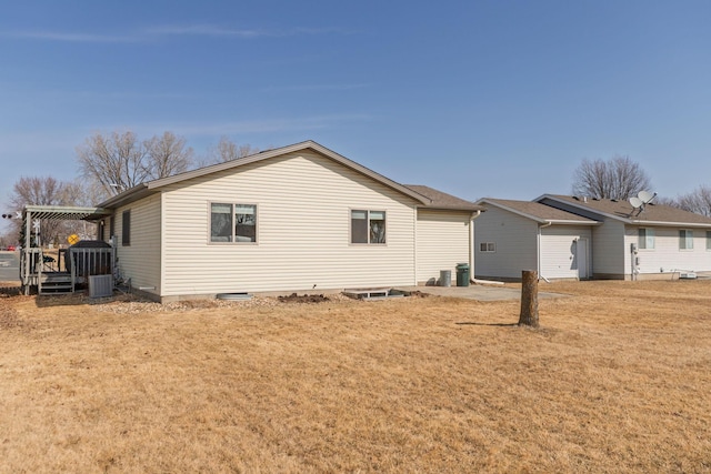 view of side of home featuring a yard and cooling unit