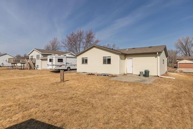 rear view of property featuring a patio area and a lawn