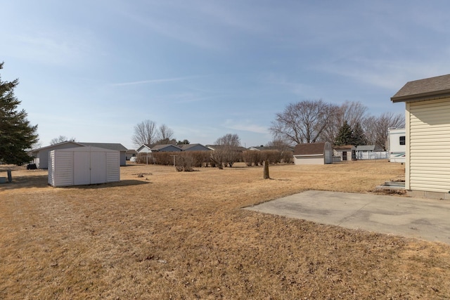 view of yard featuring an outbuilding and a shed