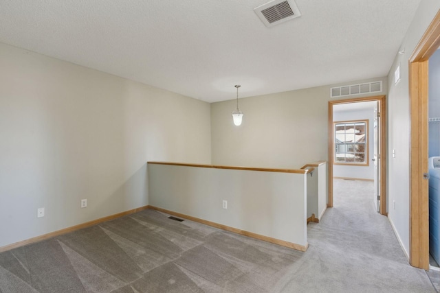 empty room with visible vents and carpet